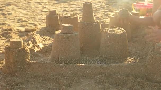 Main d'enfant, château de sable . — Video