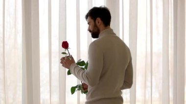 Sakallı adam gül tutan.