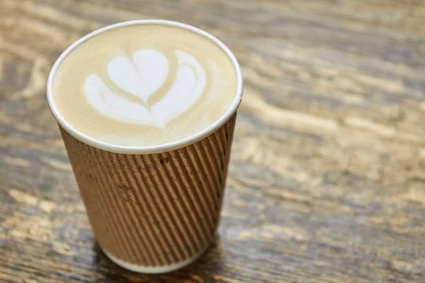 Latte art in paper cup. — Stock Photo, Image
