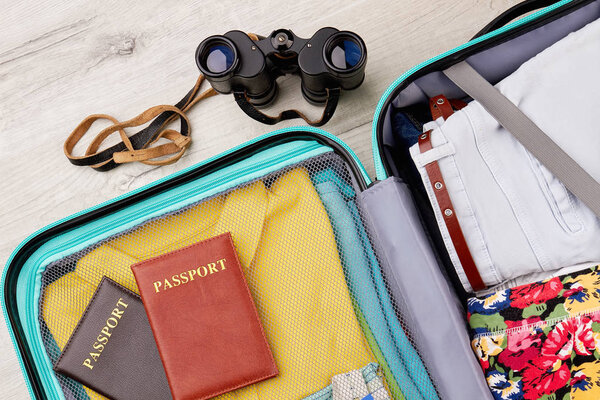 Full suitcase, passports, binocular.