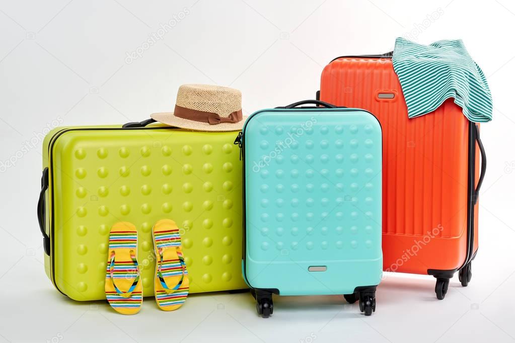 Three different suitcases, summer clothes.