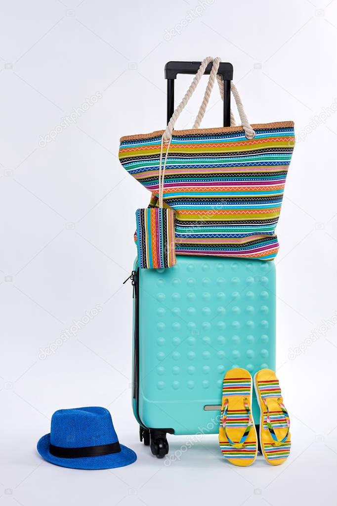 Beach accessories and wheeled suitcase.