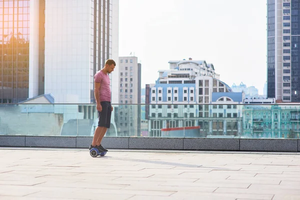 Mannen på hoverboard, staden bakgrund. — Stockfoto