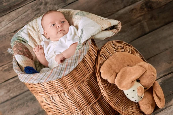 Cute baby in willow basket. — Stock Photo, Image