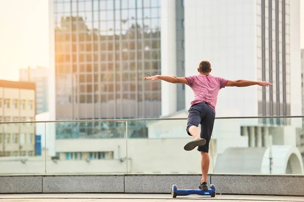 Man on hoverboard, back view. — Stock Photo, Image