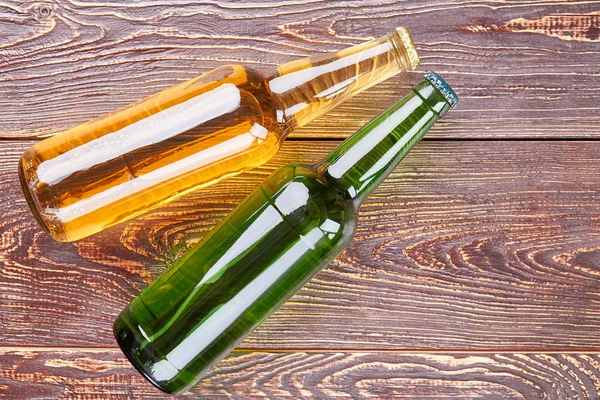 Bottles of beer on old wooden table. — Stock Photo, Image