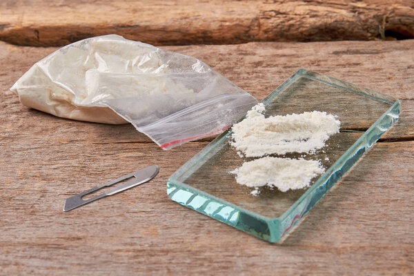 Illegal narcotic preparations, wooden background.