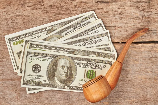 American money, wooden pipe for smoking.