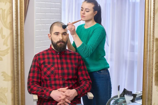 Bearded model and makeup artist.