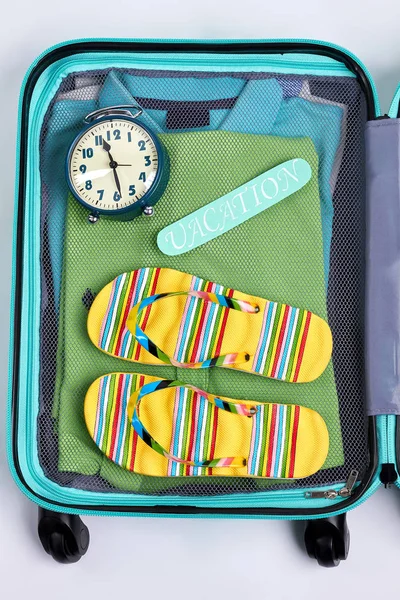 Open suitcase, alarm clock, flips.