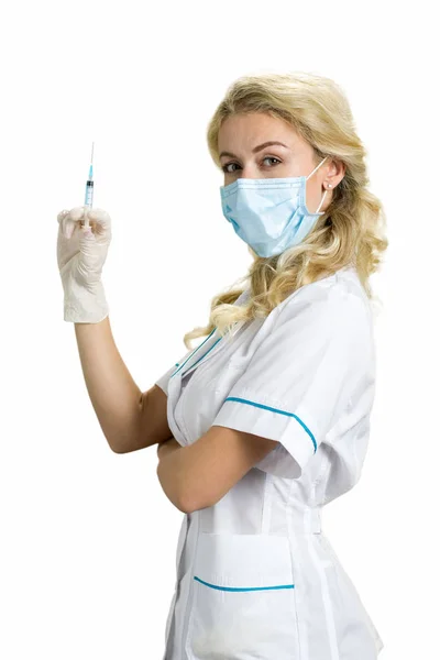 Beautiful blond nurse with syringe. Royalty Free Stock Images