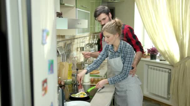 Casal na cozinha fritando ovos . — Vídeo de Stock