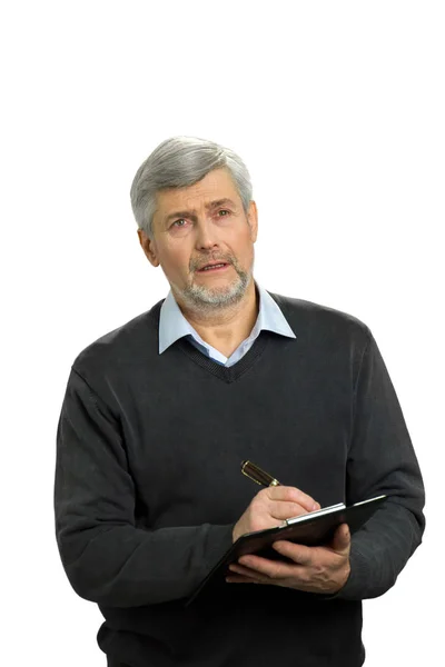 Thinking mature man with clipboard. — Stock Photo, Image