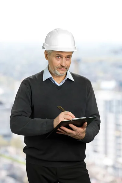 Mature architect looking on object. — Stock Photo, Image