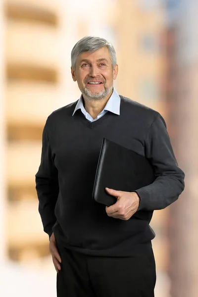 Smiling mature man holding folder. — Stock Photo, Image