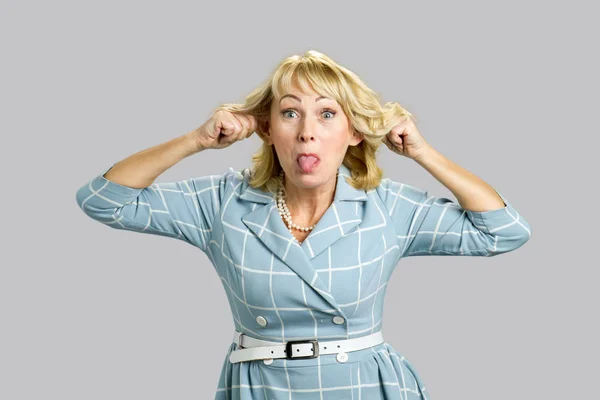 Mature attractive woman making grimace. — Stock Photo, Image