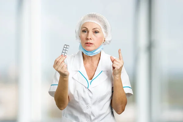 Female doctor with medical pills.