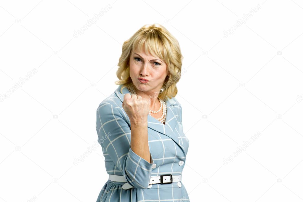 Angry mature woman making a fist.