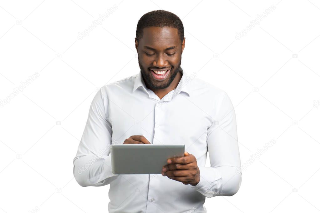 Elated businessman using pc tablet.