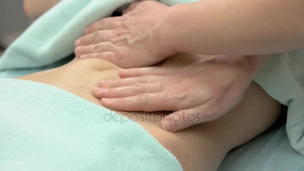 Hands massaging female belly. — Stock Video