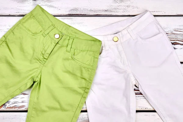 Green and white kids trousers.