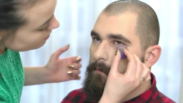 Bearded man getting makeup. — Stock Video