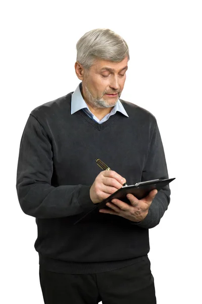 Confident senior supervisor writing on clipboard. — Stock Photo, Image