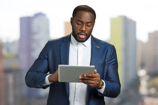 Black businessman with digital tablet.