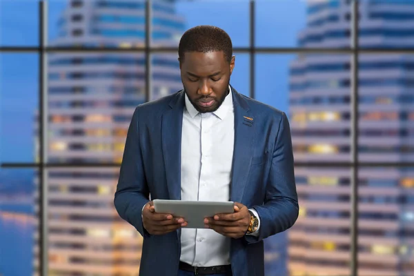 Handsome businessman holding computer tablet.