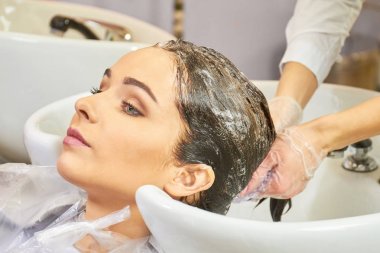 Kadın kafasını elde yıkanır.