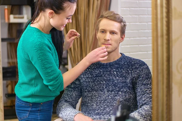 Makeup artist, young male model.