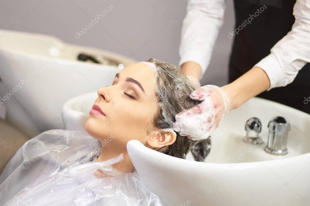 Lady getting her head washed.