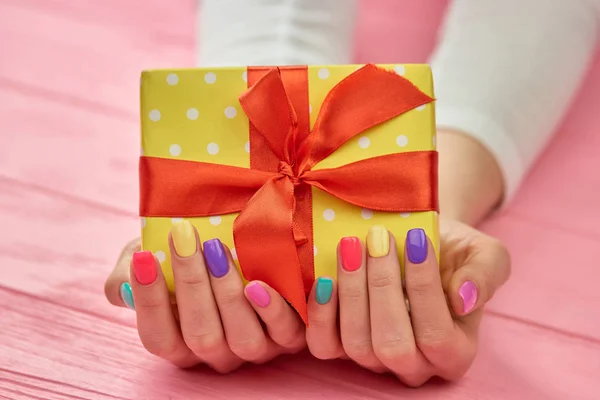 Birthday box in female hands.