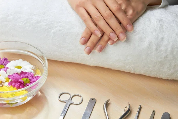 Female hands on white towel.