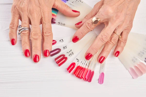 Senior woman hands with red manicure. — Stock Photo, Image
