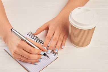 Kadın el üstünde defter yazma.