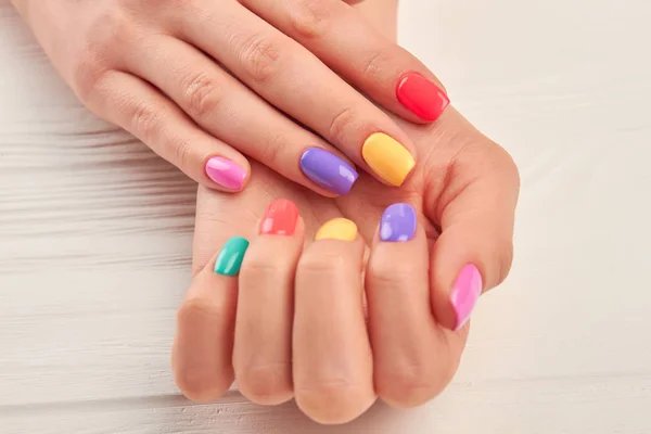 Las manos femeninas con la manicura de verano con estilo . — Foto de Stock