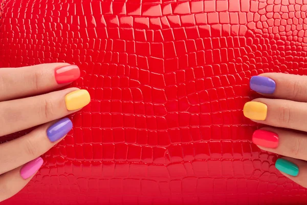 Close up red bag in manicured hands. — Stock Photo, Image