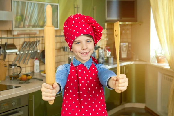 Smiling boy with kitchen utensils. — Stock Photo, Image