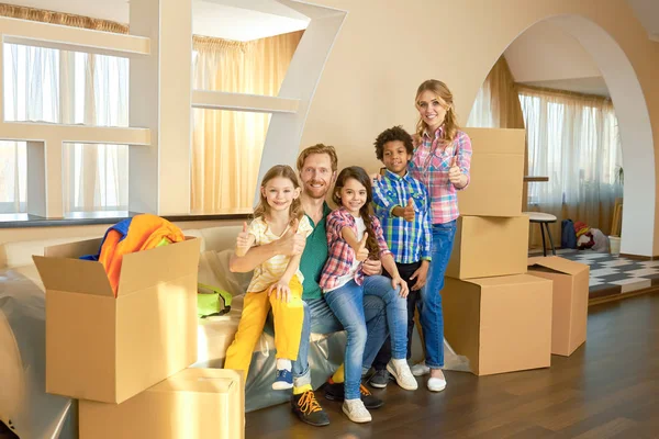 Family showing thumbs up indoor. — Stock Photo, Image
