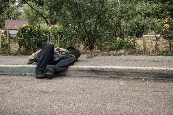 Unconscious drunk man outdoors.