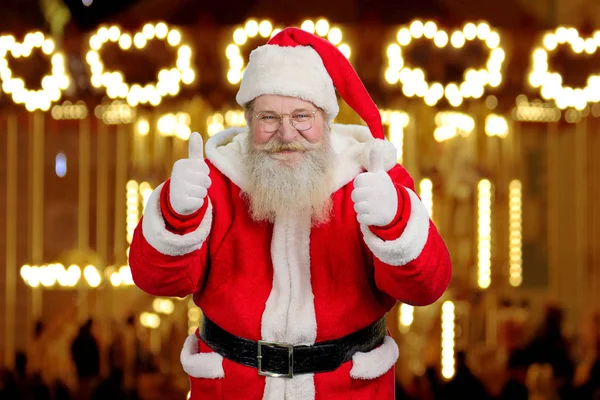 Old Santa Claus giving thumbs up with both hands.