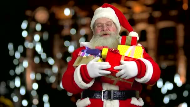 Santa laughing and holding presents. — Stock Video