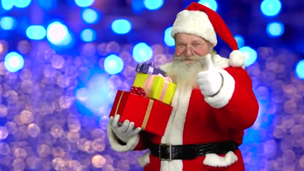 Santa showing thumb up, presents. — Stock Video