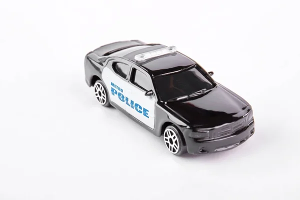 Metra policji samochód Zabawka, białe tło. — Zdjęcie stockowe