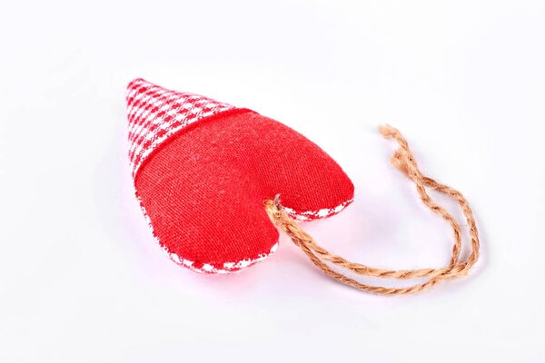 Cute handmade red heart over white.