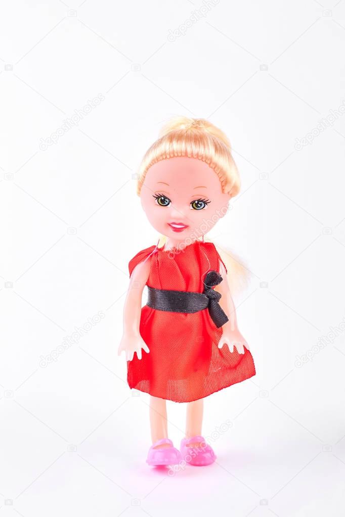 Doll in red dress on white background.