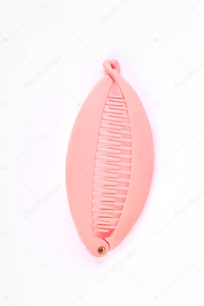 Pink hair banana clip over white.