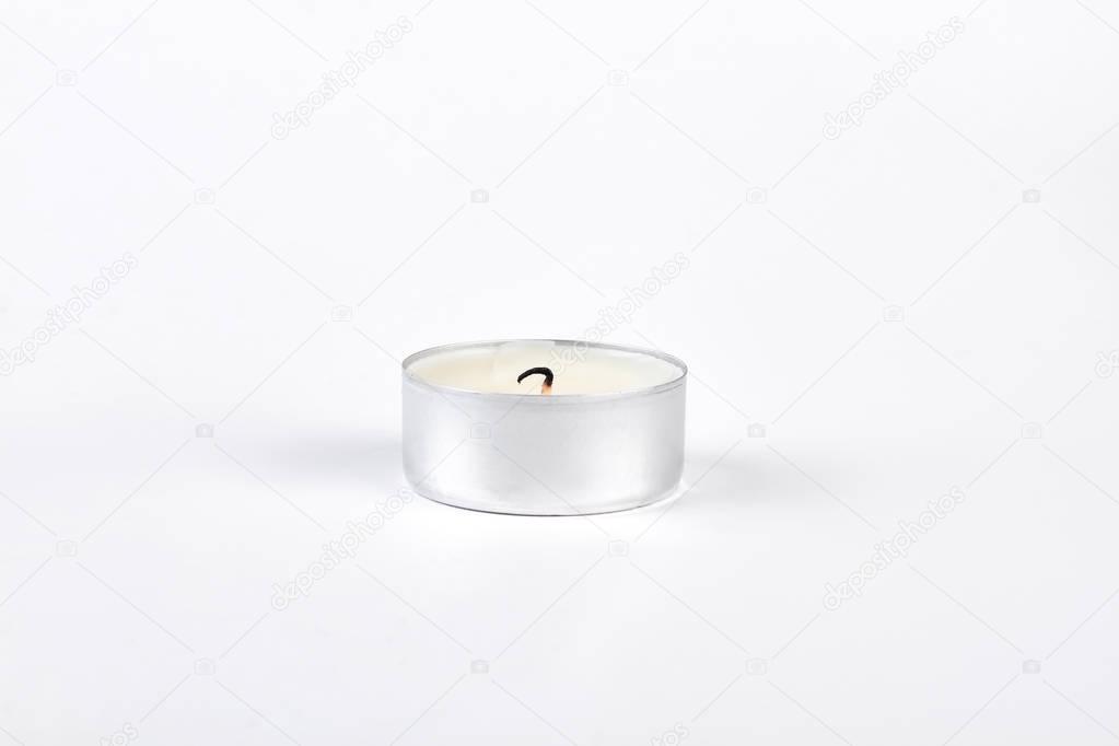 Tea candle with burned wick.
