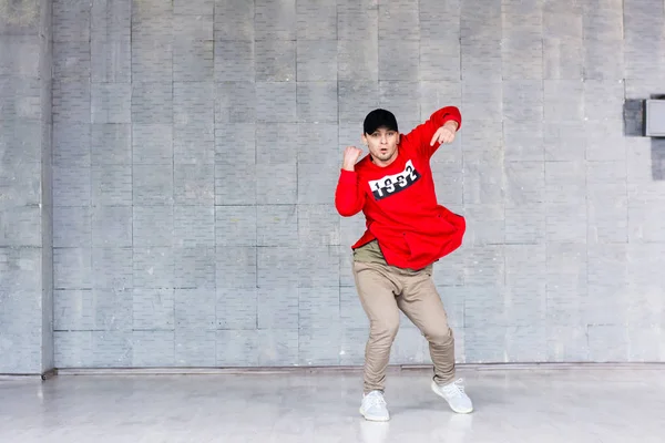 Young stylish man dancing hip-hop.